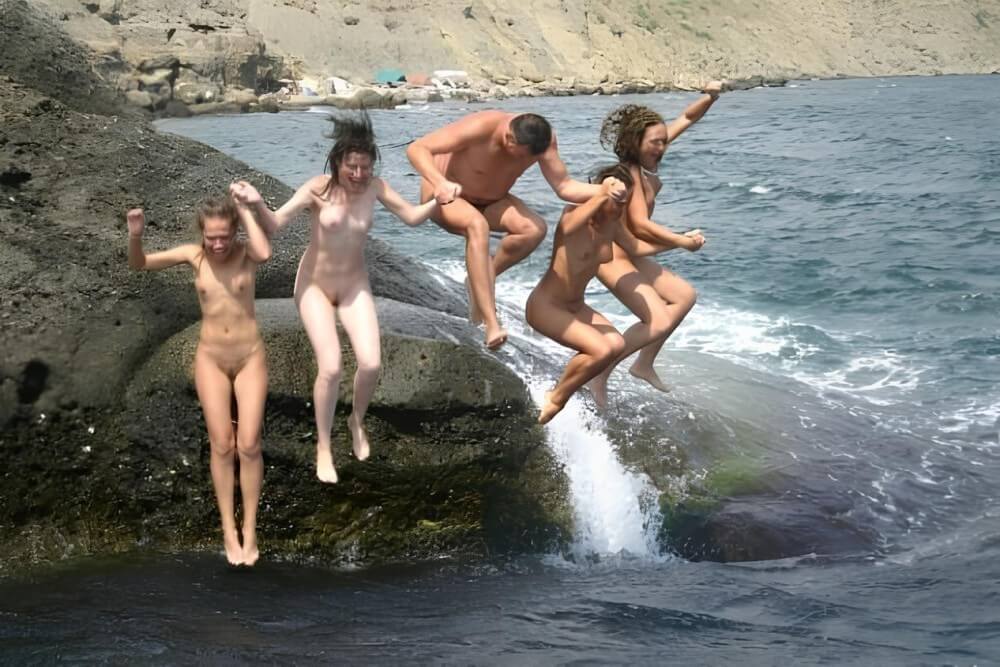 Mens and girls nudists on a beach - The practice of naturism is a path to inner harmony and peace