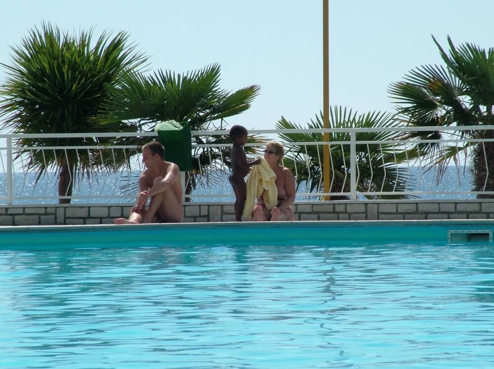 Photo of naturists in an outdoor pool - Belief in oneself and ones own strengths are important qualities for practitioners of naturism and nudism
