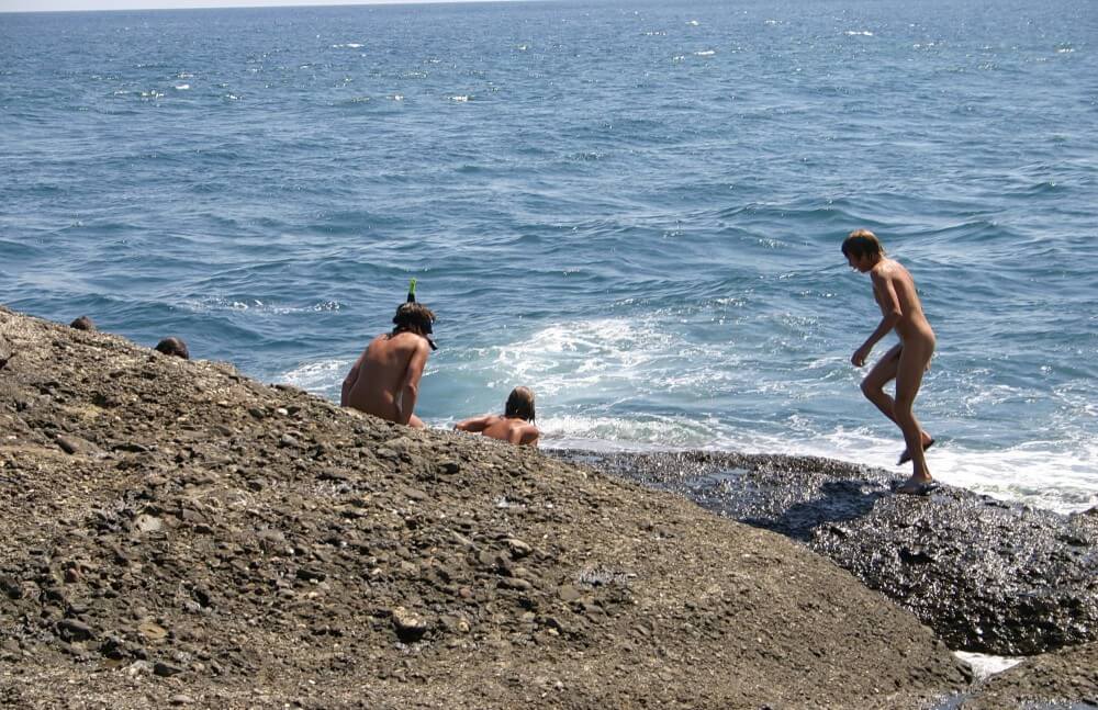 Leaning Against Hit Rocks pics - Lightheartedness and ease are characteristic features of the practice of nudism and naturism